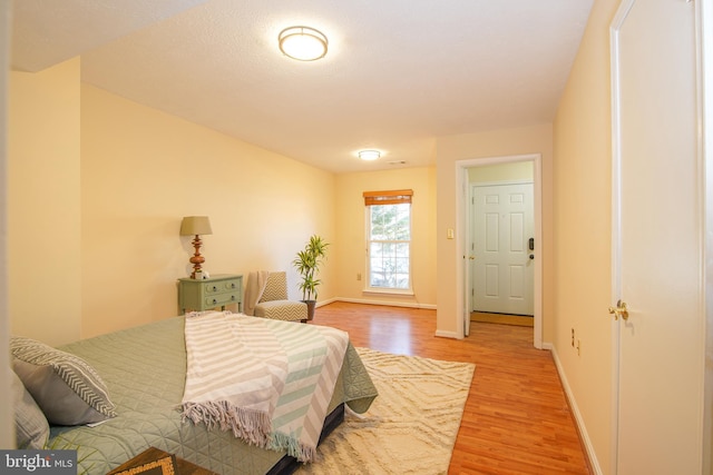 bedroom with baseboards and light wood-style flooring