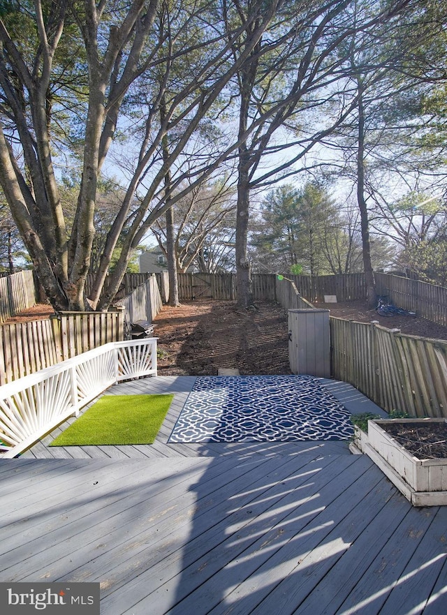 wooden deck featuring a fenced backyard