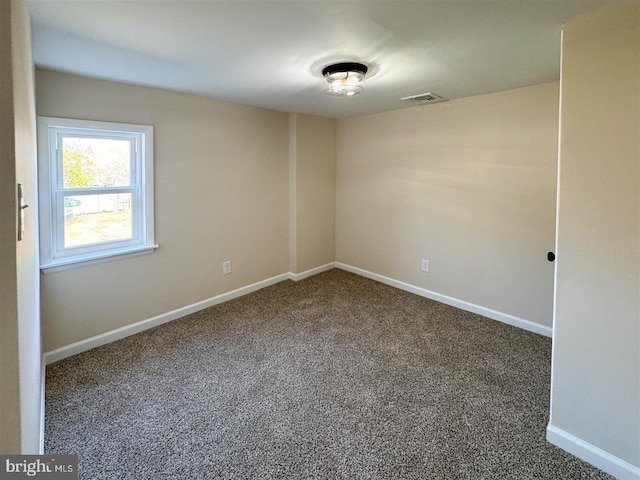 carpeted empty room with visible vents and baseboards