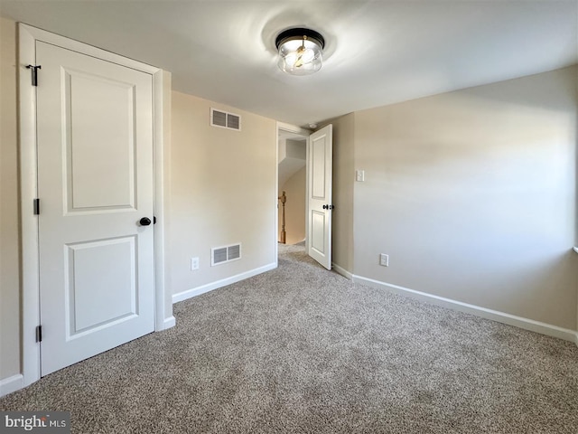 unfurnished bedroom with visible vents, baseboards, and carpet flooring