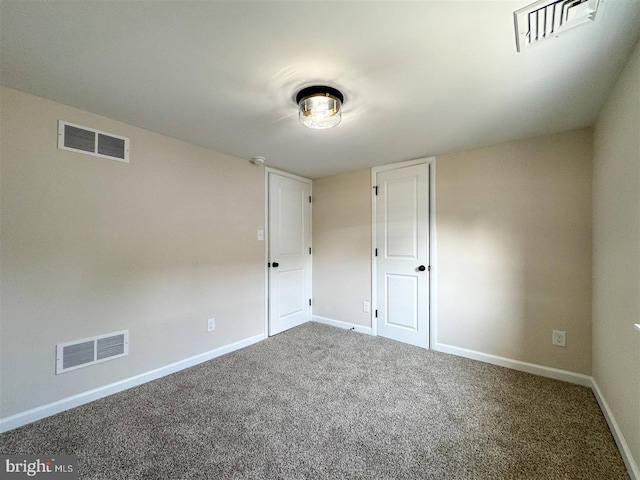 carpeted empty room with baseboards and visible vents