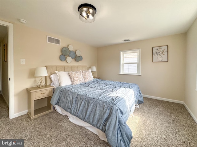 bedroom featuring visible vents, baseboards, and carpet