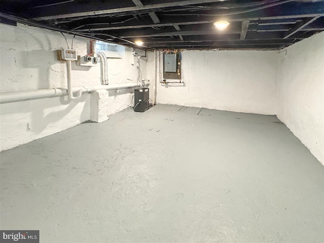 unfinished basement featuring electric panel