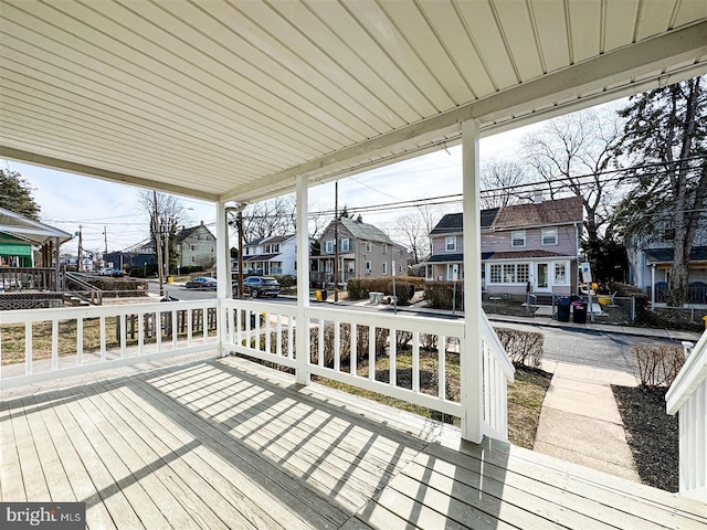 deck with a residential view and a porch