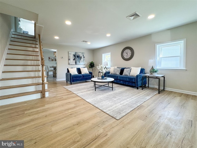 living room with stairway, wood finished floors, visible vents, baseboards, and recessed lighting