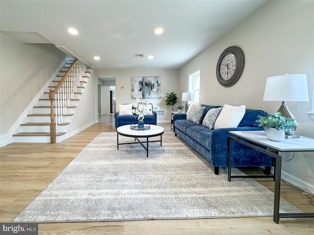 living room with stairway, recessed lighting, wood finished floors, and baseboards