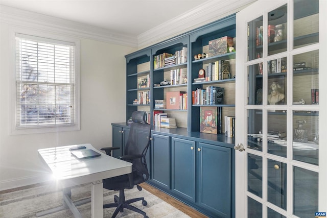 office area with light wood-style floors and ornamental molding