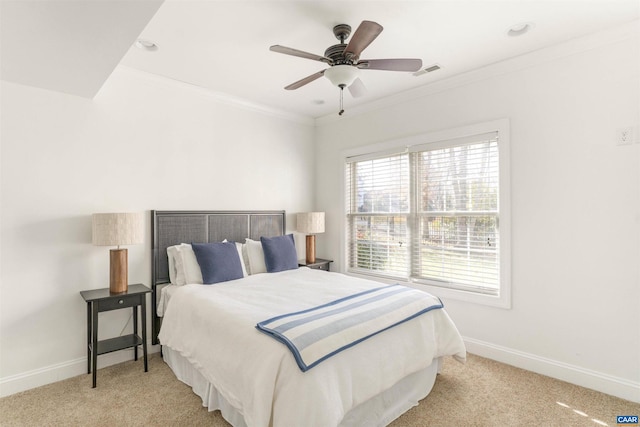 carpeted bedroom with ceiling fan, baseboards, visible vents, and ornamental molding