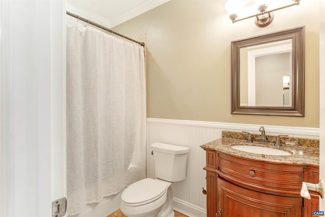 full bath featuring a wainscoted wall, toilet, vanity, and crown molding