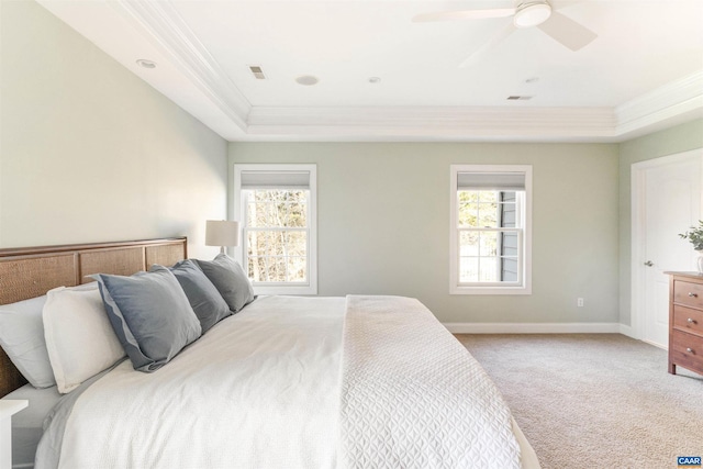 carpeted bedroom with baseboards, multiple windows, visible vents, and crown molding