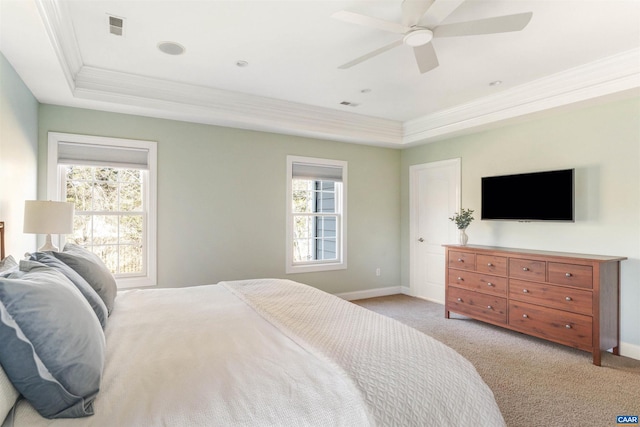 bedroom featuring baseboards, a raised ceiling, carpet flooring, and crown molding