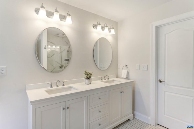 bathroom featuring double vanity, baseboards, and a sink