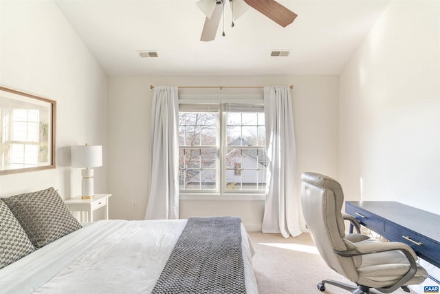 bedroom with visible vents, multiple windows, and carpet flooring