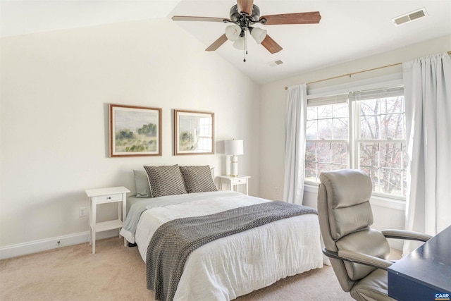 bedroom with visible vents, multiple windows, light colored carpet, and vaulted ceiling