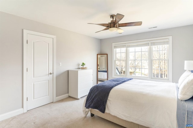 carpeted bedroom featuring a ceiling fan, baseboards, and visible vents