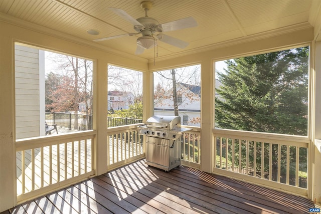 sunroom with a healthy amount of sunlight and ceiling fan