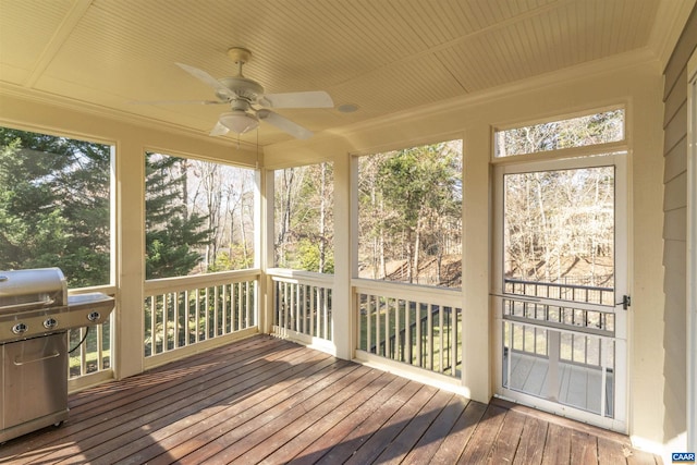 unfurnished sunroom featuring a ceiling fan