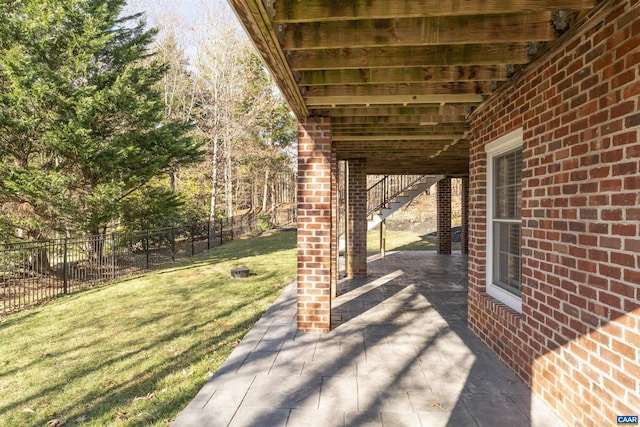 view of patio / terrace with stairway and fence