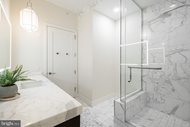 bathroom featuring marble finish floor, recessed lighting, a marble finish shower, baseboards, and vanity