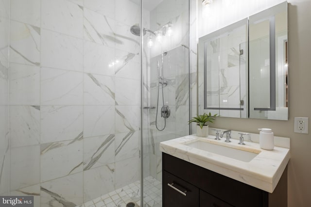 full bathroom with a marble finish shower and vanity