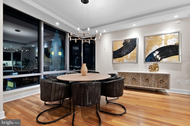 dining room with recessed lighting, wood finished floors, and a chandelier