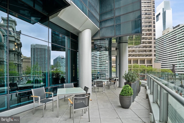 view of patio with a view of city and a balcony