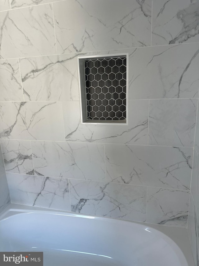 bathroom featuring washtub / shower combination