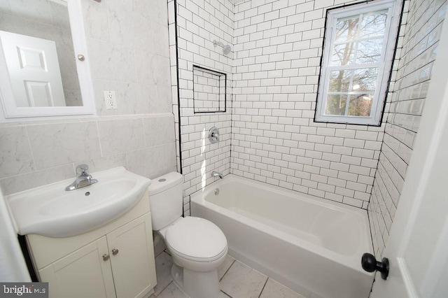 bathroom featuring toilet, tile walls, bathtub / shower combination, and vanity