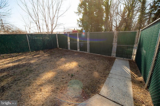 view of yard with fence and a gate