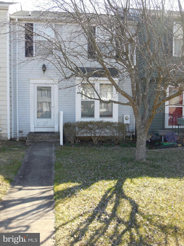 entrance to property with a lawn