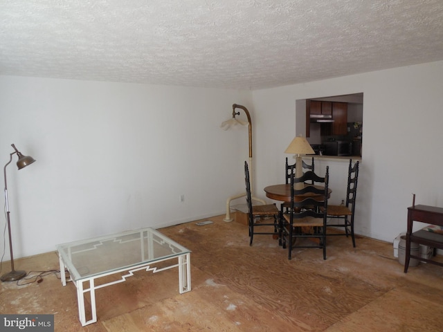 dining space with a textured ceiling