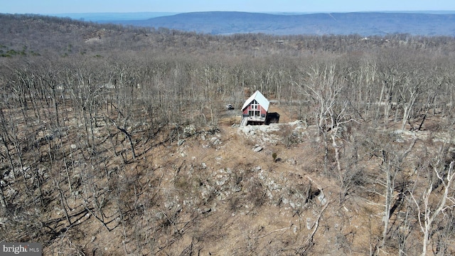 birds eye view of property with a view of trees