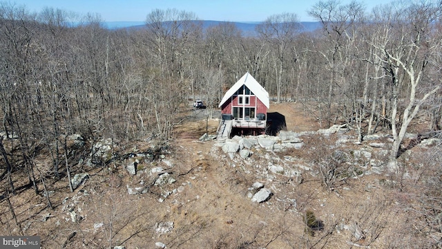 exterior space with a wooded view