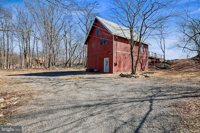 exterior space featuring an outbuilding, a barn, and driveway