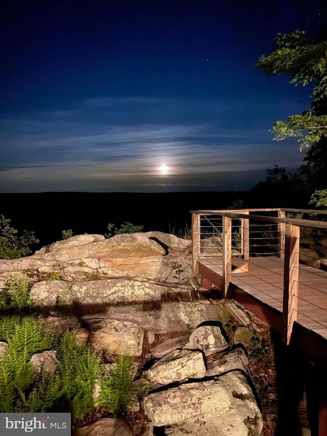 yard at night with a deck