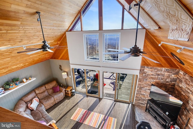 living room with high vaulted ceiling, wooden walls, wood ceiling, and ceiling fan