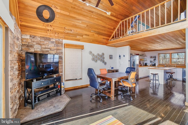 dining space featuring vaulted ceiling, wooden ceiling, baseboards, and wood finished floors