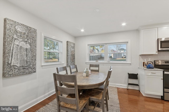 dining room with recessed lighting, baseboards, and dark wood finished floors