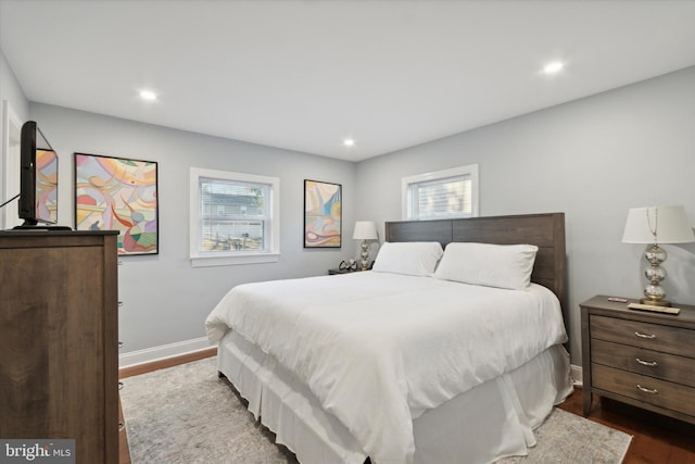 bedroom featuring recessed lighting, dark wood-type flooring, and baseboards