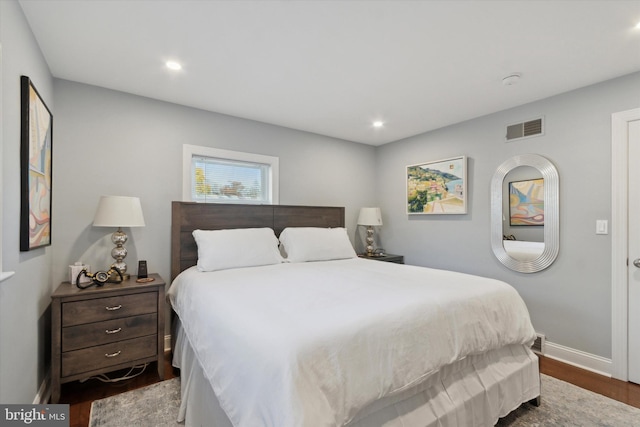 bedroom with visible vents, recessed lighting, dark wood-type flooring, and baseboards