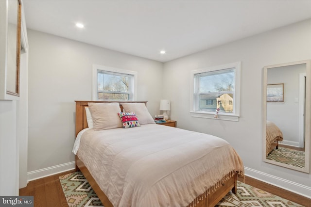 bedroom with recessed lighting, baseboards, and wood finished floors