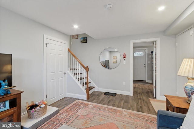 interior space featuring stairs, recessed lighting, wood finished floors, and baseboards