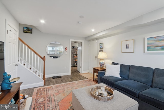 living room with stairway, recessed lighting, wood finished floors, and baseboards