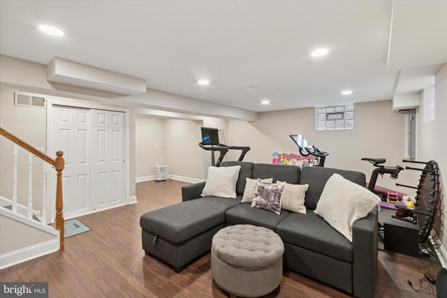 living area with visible vents, wood finished floors, recessed lighting, baseboards, and stairs