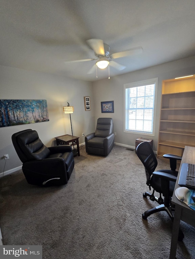 carpeted office featuring baseboards and ceiling fan