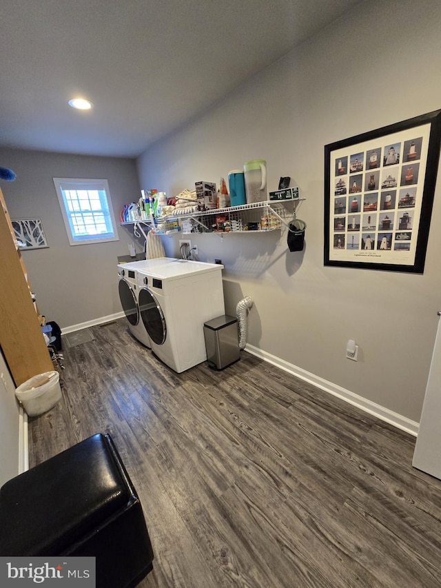 clothes washing area with baseboards, laundry area, recessed lighting, dark wood-type flooring, and washer and clothes dryer