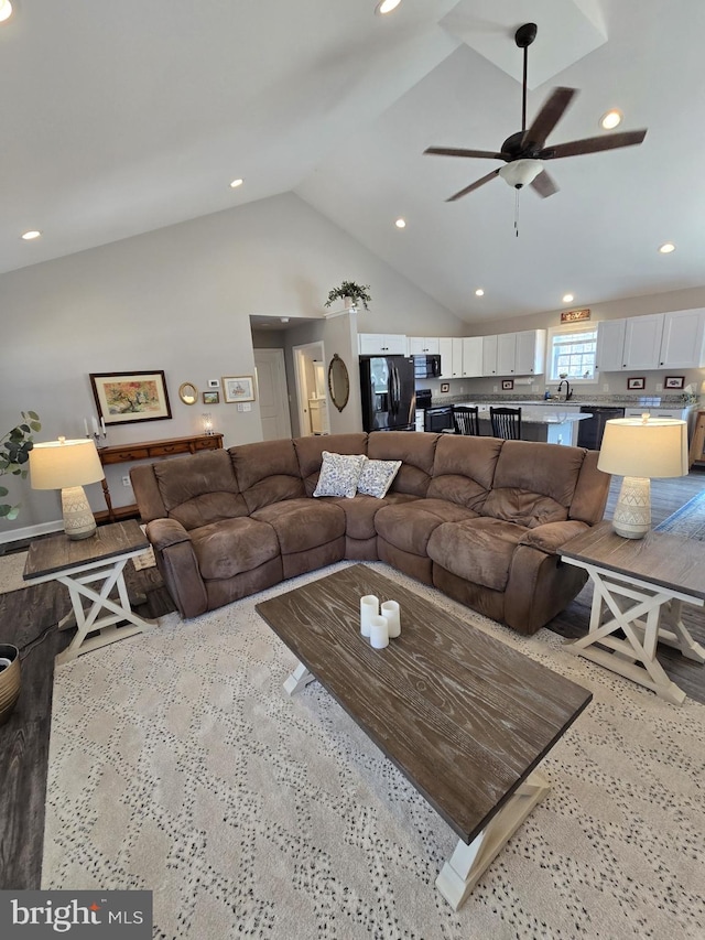 living area with recessed lighting, a ceiling fan, and high vaulted ceiling