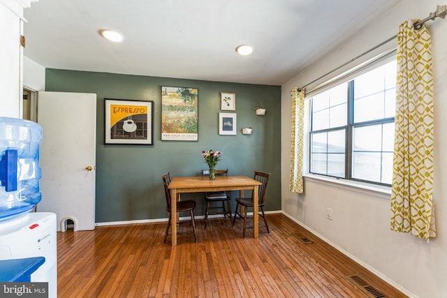 dining area with visible vents, baseboards, and wood-type flooring