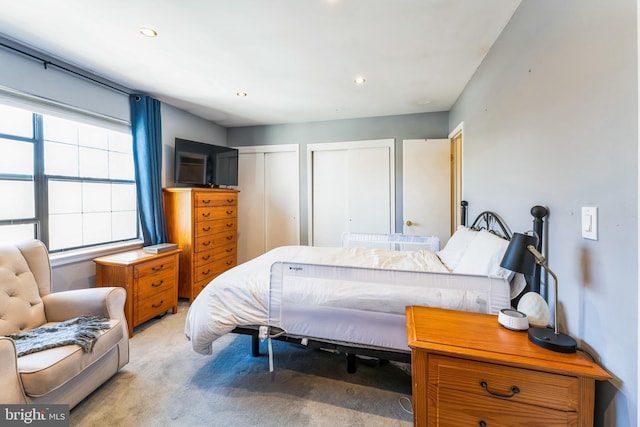 bedroom featuring recessed lighting, two closets, and carpet