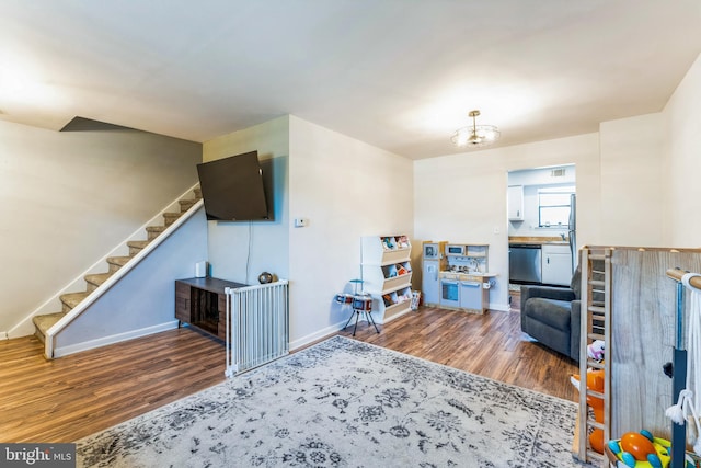 interior space with baseboards, wood finished floors, and stairs